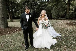 black tuxedo with bride in her white wedding gown